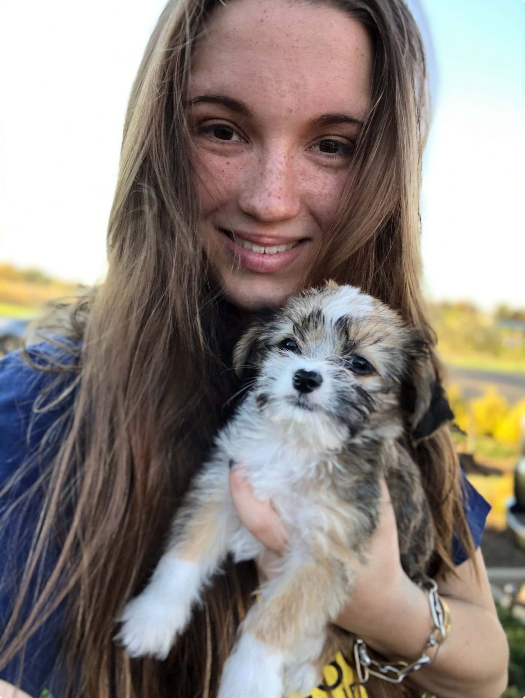 Adopter holding a rescued puppy
